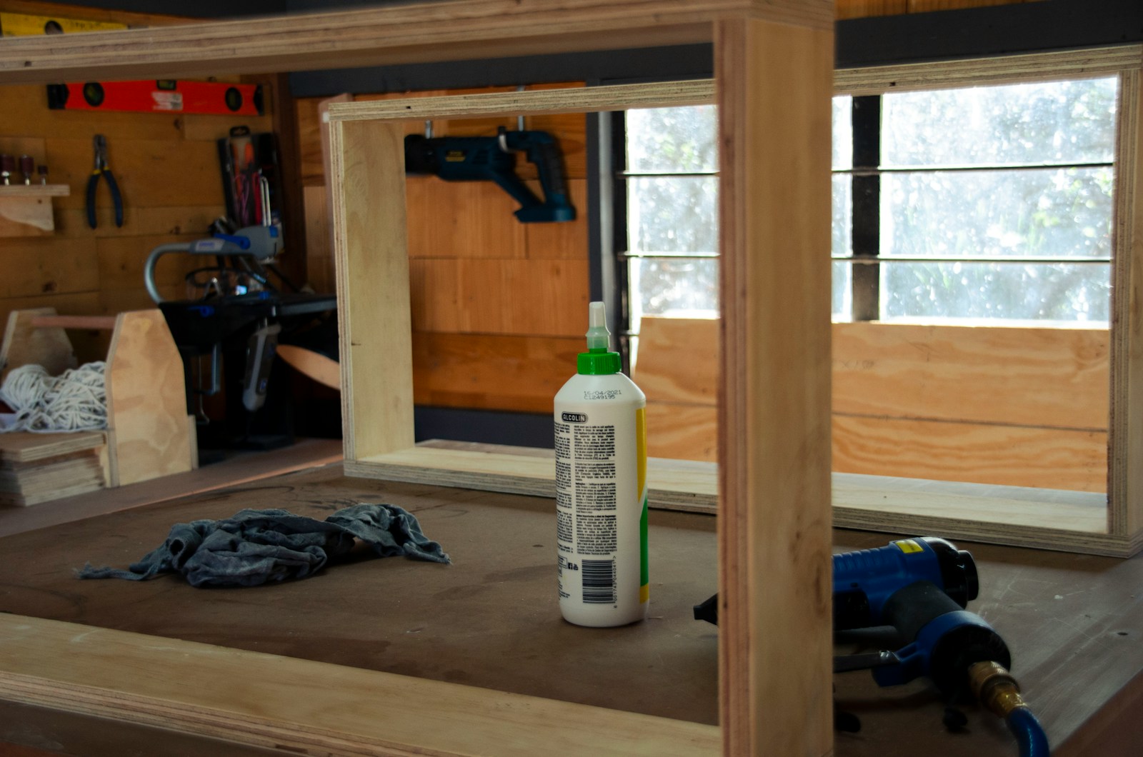 a bottle of glue sitting on top of a wooden table