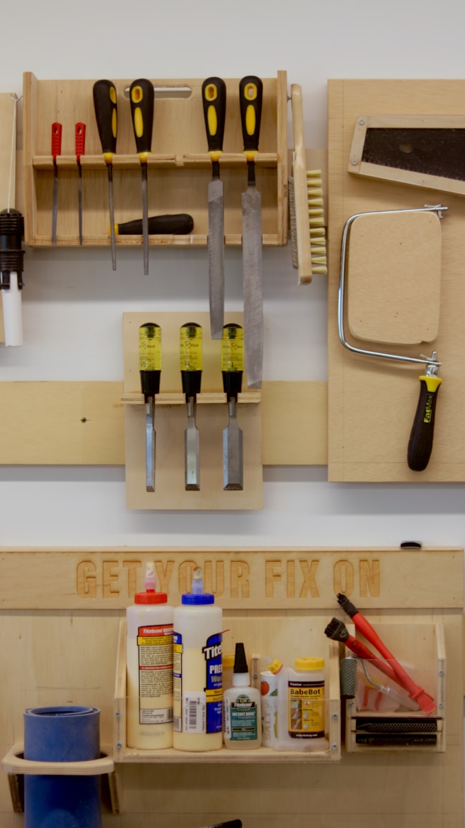 a workbench with tools hanging on the wall